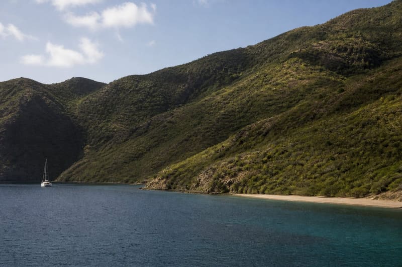Chatham Bay on Union Island: an empty anchorage, steep green hills, no buildings.