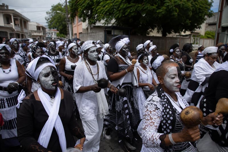 Ash Wednesday in the French Antilles: a street crowd dressed entirely in black and white, moving together.