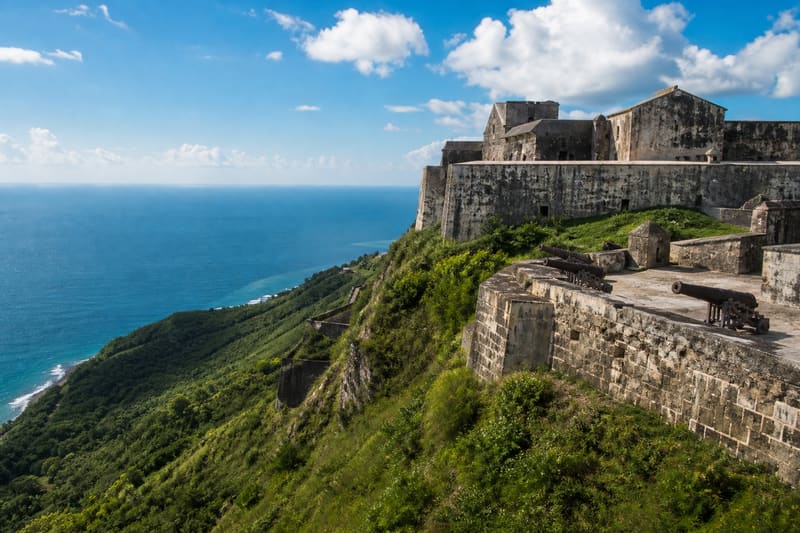 An eighteenth-century stone fortress with cannon on a volcanic outcrop high above the sea.